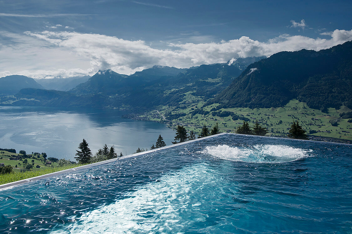 Infinity pool at Villa Honegg overlooking Lake Lucerne and the surrounding Swiss Alps
