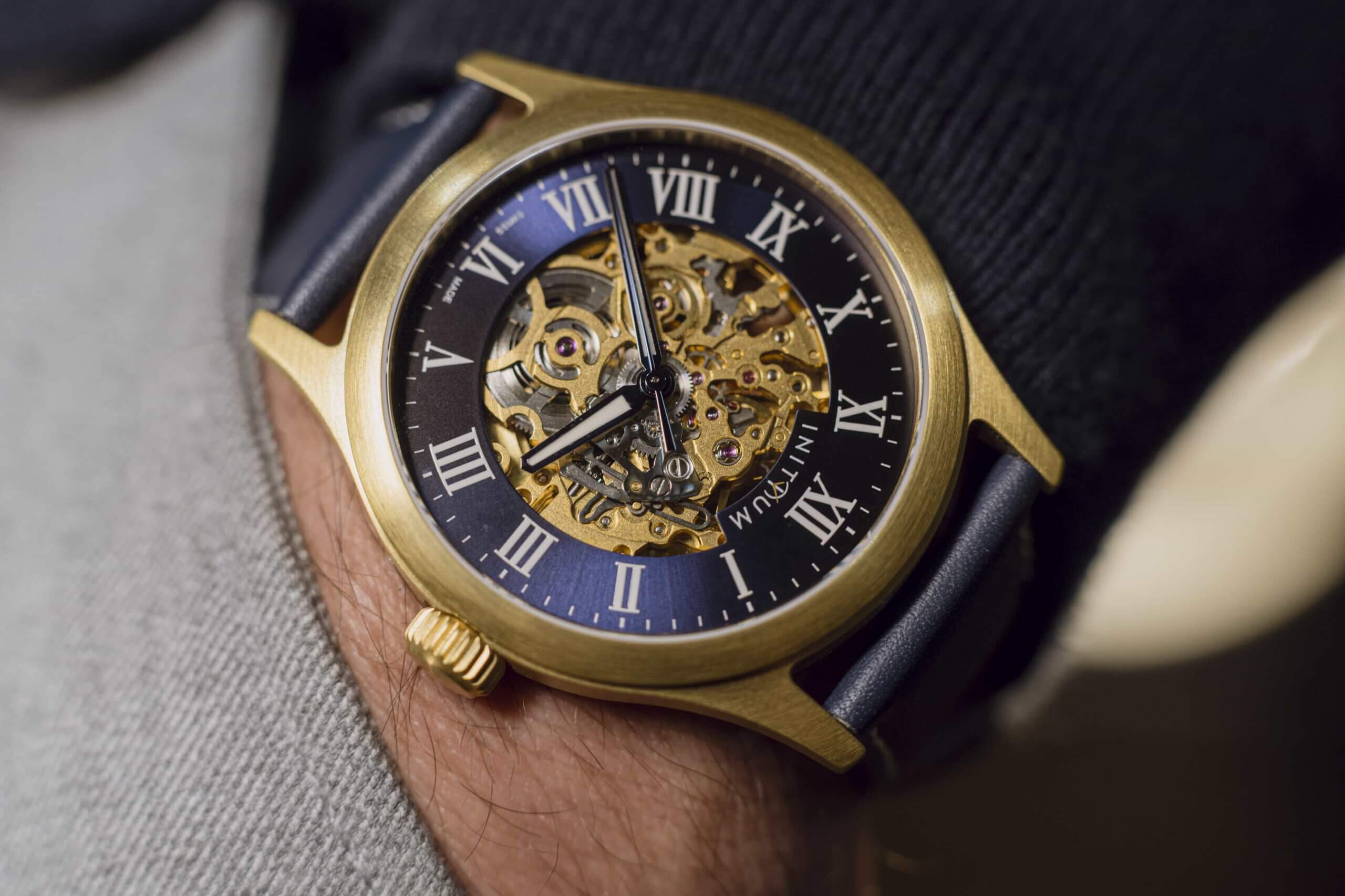 Finished automatic watch model from a Swiss watchmaking workshop showcasing a mechanical movement and craftsmanship
