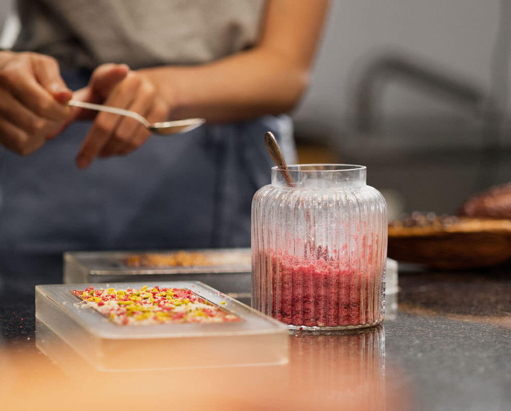 Guest creating a bespoke chocolate bar during a Swiss chocolate workshop