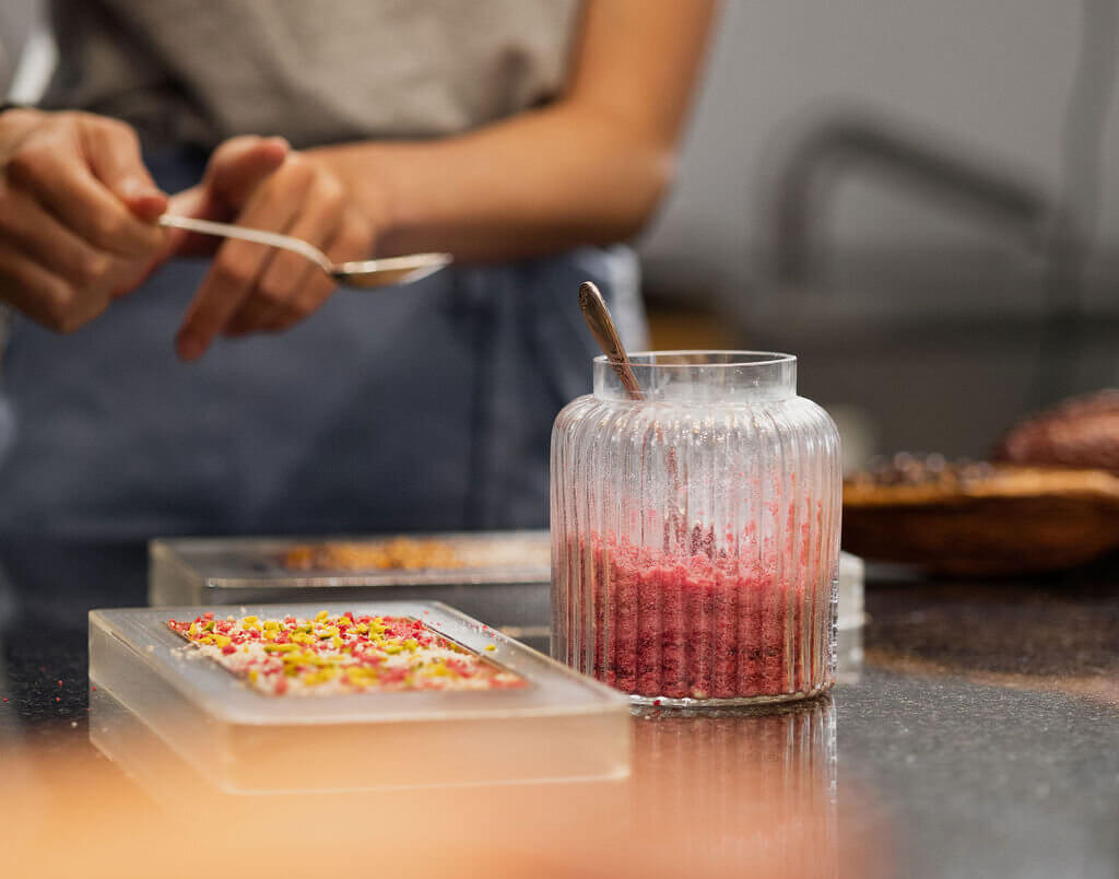 Guest creating a bespoke chocolate bar during a Swiss chocolate workshop